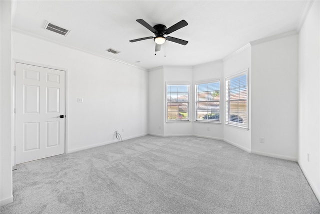 carpeted empty room with ceiling fan and ornamental molding