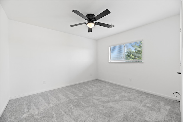 spare room with light carpet and ceiling fan