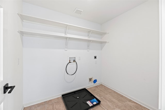 laundry area with hookup for a washing machine, light tile patterned floors, and electric dryer hookup