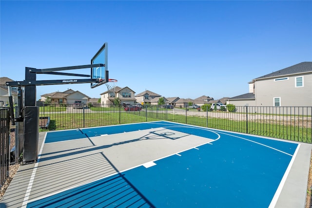 view of basketball court featuring a yard