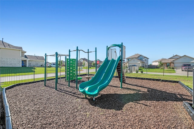 view of playground with a lawn