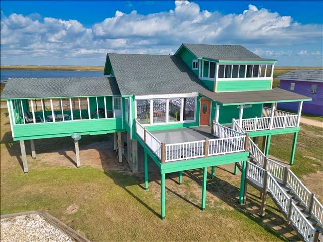 view of play area featuring a sunroom and a yard