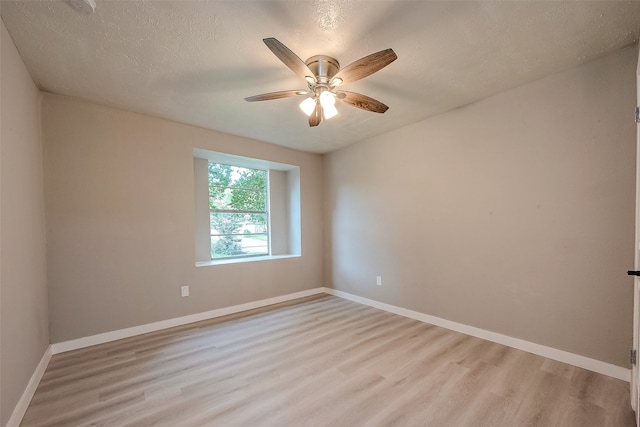 unfurnished room with ceiling fan, a textured ceiling, and light hardwood / wood-style flooring