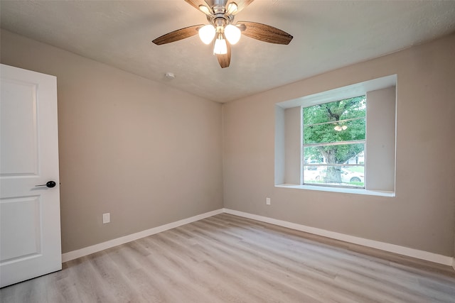 unfurnished room featuring ceiling fan, a textured ceiling, and light wood-type flooring