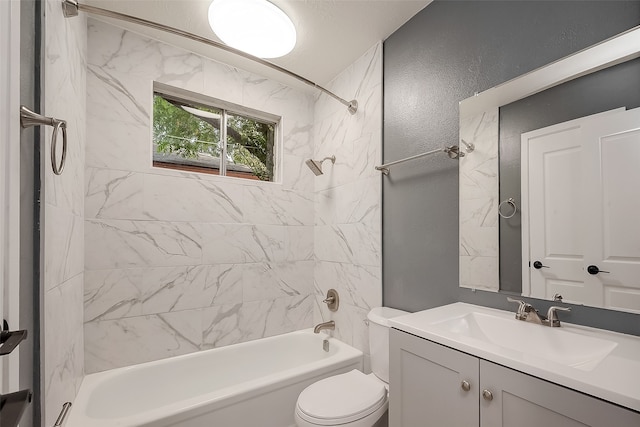 full bathroom featuring tiled shower / bath, a textured ceiling, toilet, and vanity