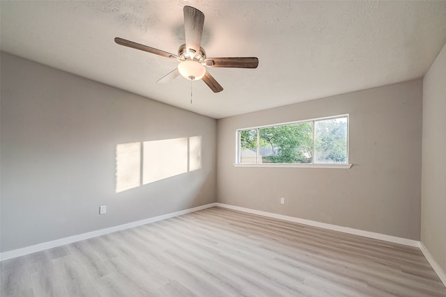 unfurnished room featuring light hardwood / wood-style floors, ceiling fan, and a textured ceiling