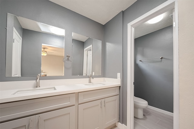 bathroom featuring vanity, ceiling fan, and toilet