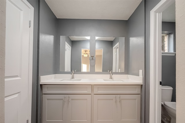 bathroom featuring toilet and vanity