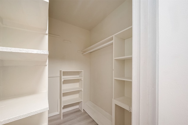 walk in closet featuring light hardwood / wood-style flooring