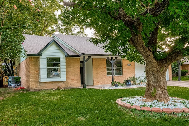 single story home with central air condition unit and a front yard