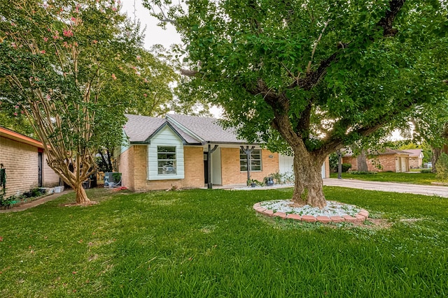 single story home featuring central AC unit and a front yard