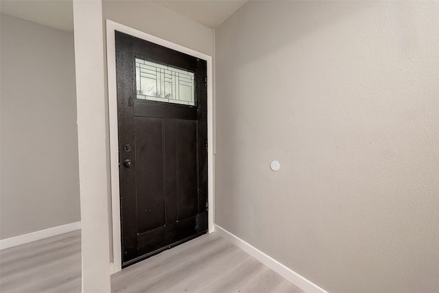 doorway to outside with light wood-type flooring