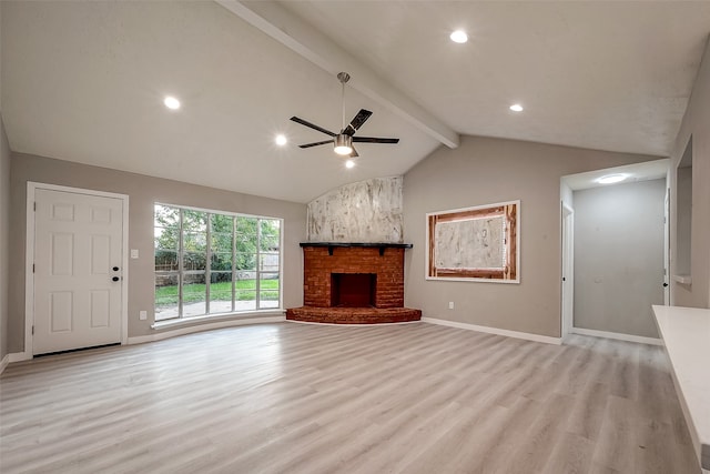 unfurnished living room featuring a brick fireplace, ceiling fan, light hardwood / wood-style flooring, and lofted ceiling with beams