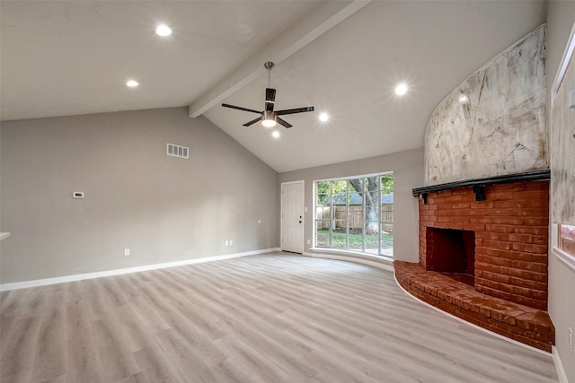 unfurnished living room with a fireplace, high vaulted ceiling, beamed ceiling, ceiling fan, and light wood-type flooring