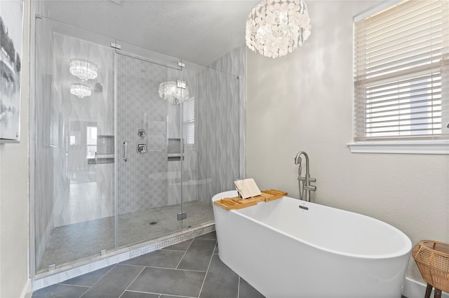 bathroom with a chandelier, plus walk in shower, a textured ceiling, and tile patterned floors