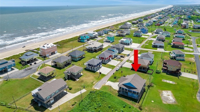 aerial view featuring a view of the beach and a water view