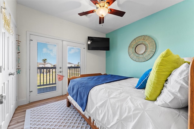 bedroom featuring french doors, light hardwood / wood-style floors, vaulted ceiling, access to exterior, and ceiling fan