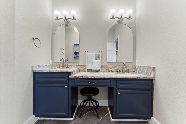 2423 Sandpiper, Crystal Beach, TX 77650 - bathroom with double vanity, tile patterned floors, and a textured wall