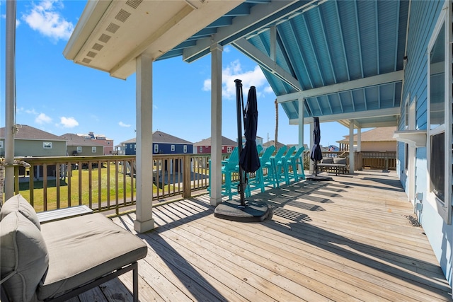 wooden deck featuring a lawn