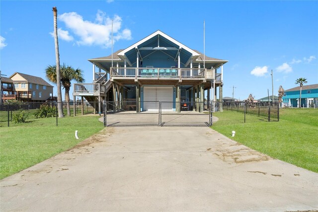 2423 Sandpiper, Crystal Beach, TX 77650 - raised beach house with concrete driveway, a gate, a garage, and a deck