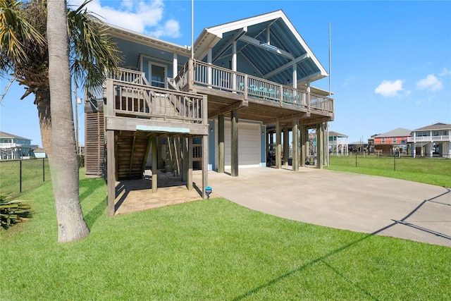 rear view of property with a lawn, a carport, and a wooden deck