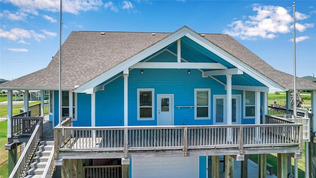 rear view of property with a garage