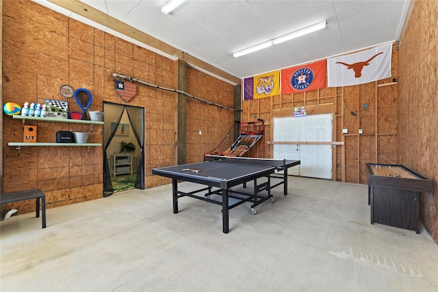 2423 Sandpiper, Crystal Beach, TX 77650 - playroom with concrete flooring and wood walls