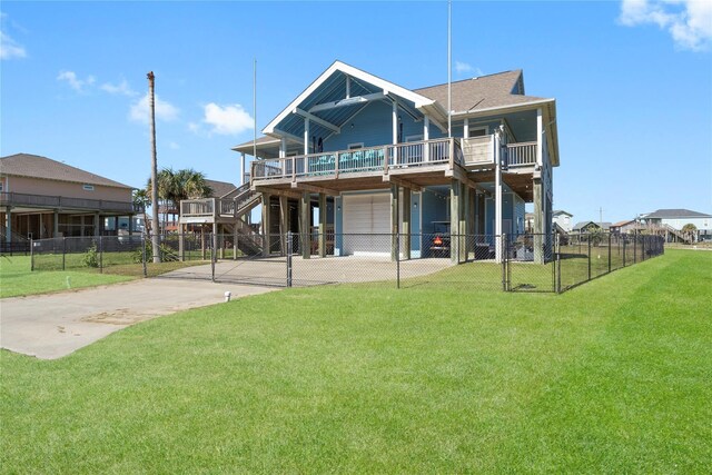 2423 Sandpiper, Crystal Beach, TX 77650 - rear view of property featuring an attached garage, concrete driveway, a wooden deck, and a gate