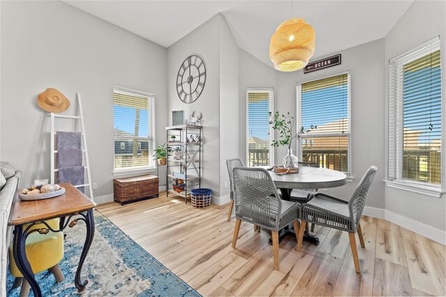 2423 Sandpiper, Crystal Beach, TX 77650 - dining room featuring wood finished floors, baseboards, and lofted ceiling