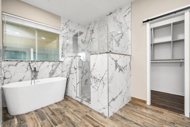 bathroom with tile walls and independent shower and bath