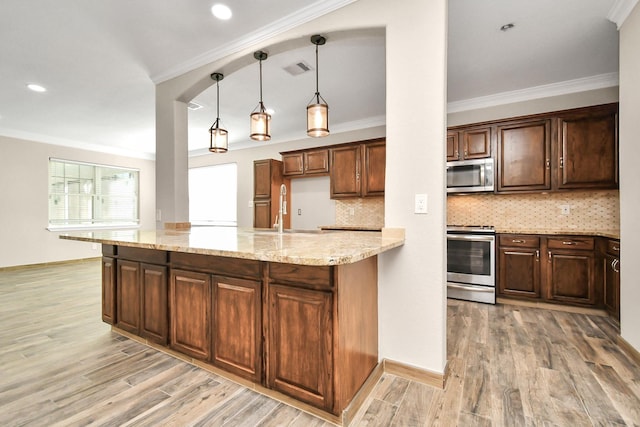 kitchen with stainless steel appliances, tasteful backsplash, light stone counters, decorative light fixtures, and ornamental molding