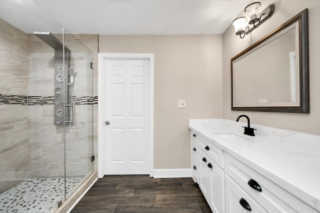 bathroom featuring hardwood / wood-style floors, vanity, and walk in shower