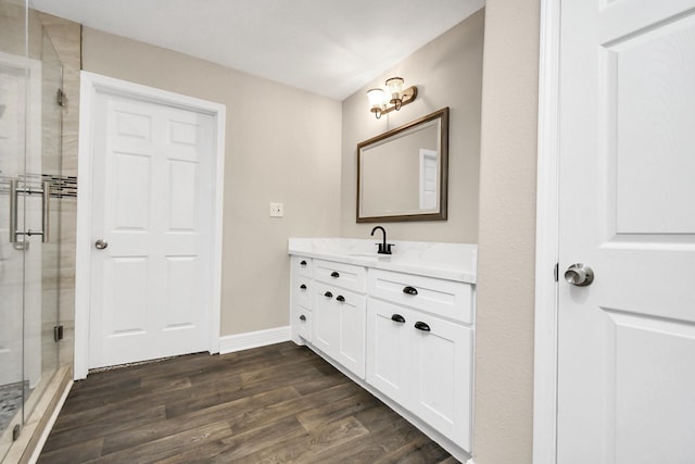 bathroom featuring hardwood / wood-style floors, vanity, and an enclosed shower