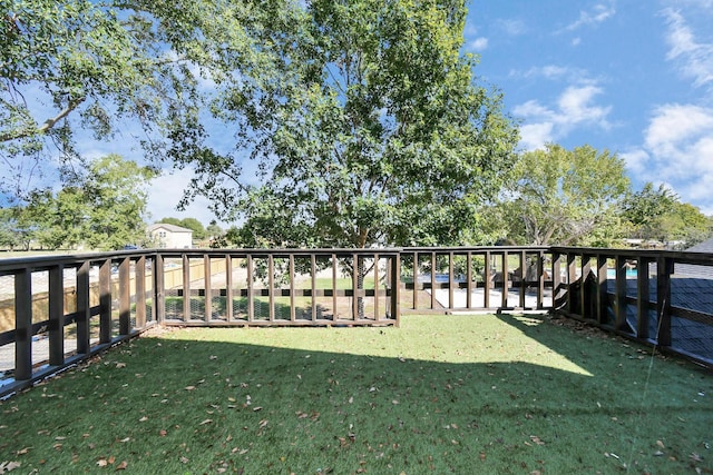 wooden terrace with a lawn