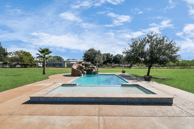 view of swimming pool featuring a yard and a water slide