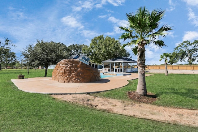 view of community featuring a gazebo, a lawn, and a pool