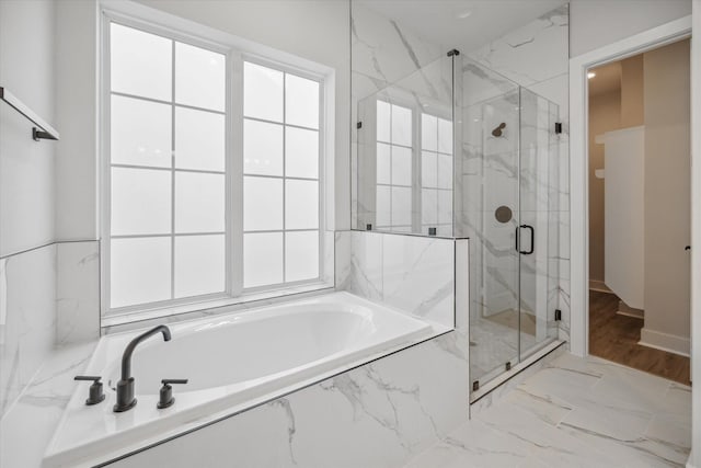 1033 W 17th St, Houston, TX 77008 - bathroom featuring plenty of natural light, a marble finish shower, a garden tub, and marble look tile flooring