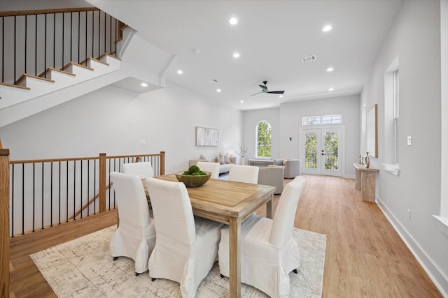 dining room with ceiling fan, french doors, and light hardwood / wood-style floors