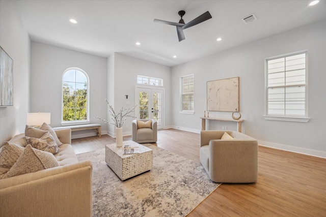 living room with ceiling fan and light hardwood / wood-style floors