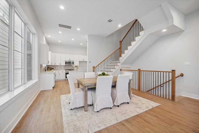 dining space with light hardwood / wood-style flooring