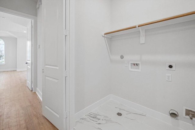 clothes washing area with hookup for a washing machine, electric dryer hookup, light hardwood / wood-style floors, and gas dryer hookup