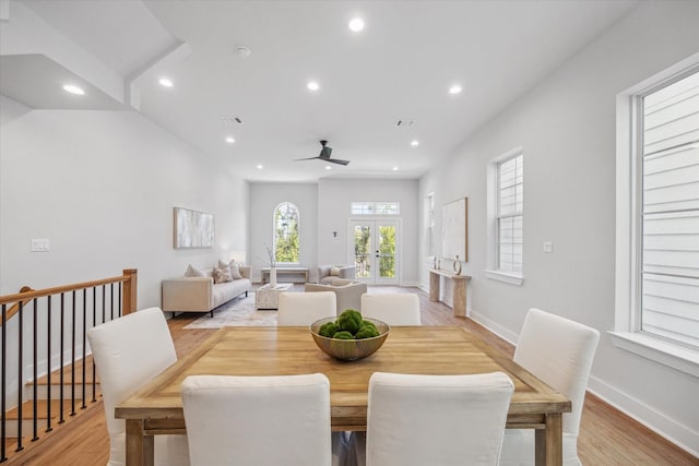 dining space with french doors, ceiling fan, and light hardwood / wood-style flooring