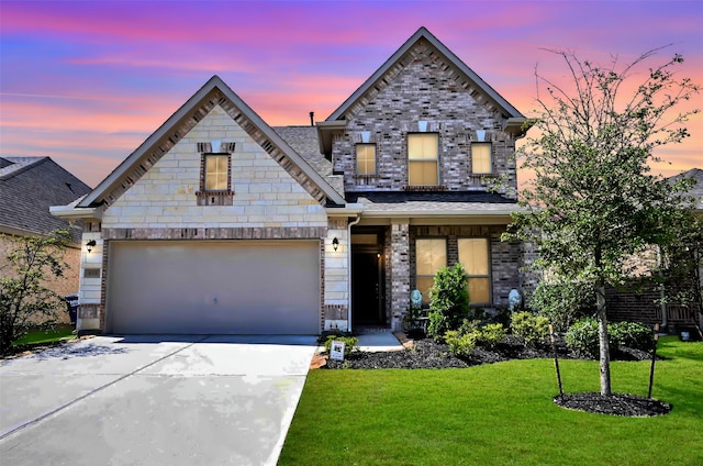 view of front of home featuring a garage and a yard