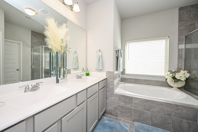 bathroom featuring independent shower and bath, vanity, and tile patterned flooring