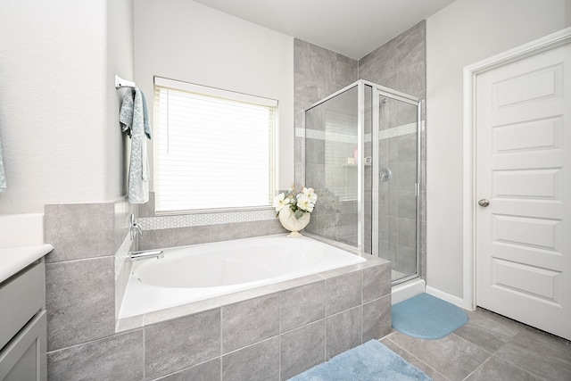 bathroom featuring vanity, tile patterned floors, and plus walk in shower