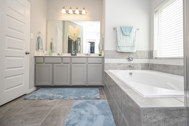 bathroom with vanity, tiled tub, and tile patterned floors