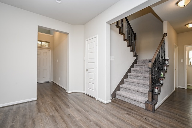 staircase with hardwood / wood-style floors