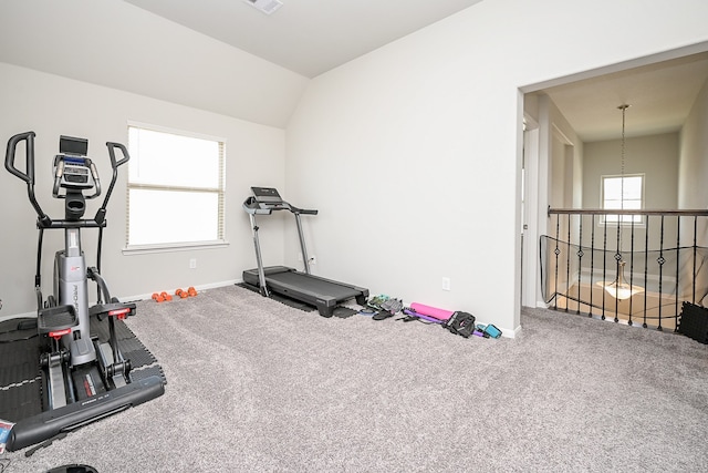 exercise room featuring carpet flooring and vaulted ceiling