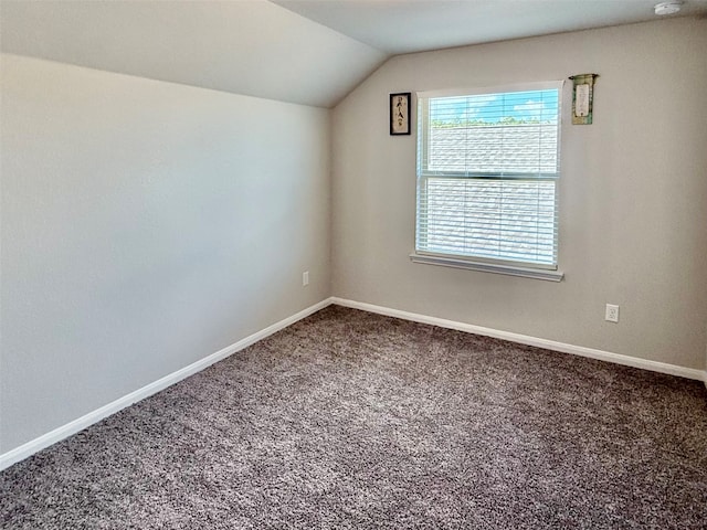 additional living space featuring carpet flooring and vaulted ceiling