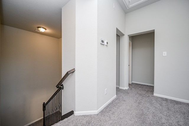 hall with light colored carpet